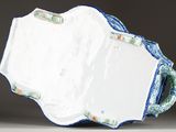 a large blue and white plate with a handle on a table