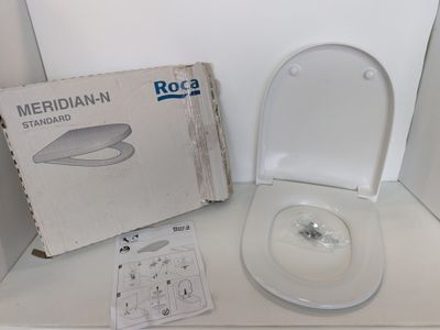 a white toilet with a box on the side of it
