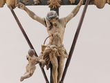 a statue of jesus on a cross with a child on it