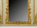 a mirror that has a gold frame on it