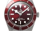 tudor watches with red dials and a stainless steel bracelet