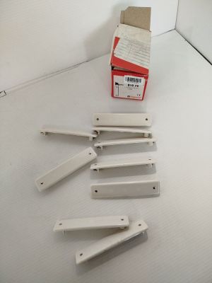 five pieces of white plastic sitting on a white surface