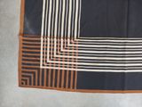 an image of a black and white and orange square scarf