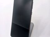 a cell phone that is sitting on top of a stand