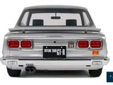 the back end of a silver car with a license plate on it