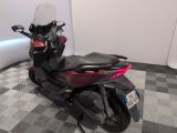 a motorcycle that is parked on a checkered floor