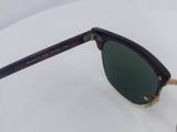 a close up of a pair of sunglasses on a white surface