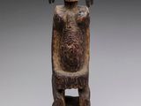 an image of a statue of a man sitting on a chair