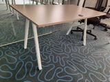 a table with chairs and a laptop on it in a conference room