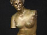 bronze sculpture of a female nude torso on a marble base