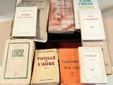 a lot of books that are sitting on top of a table