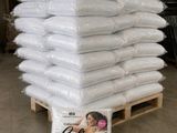 a stack of pillows on a pallet in a warehouse
