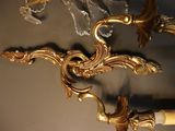 a pair of wall sconces hanging on a wall