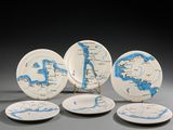 quatre assiettes ornées d'une carte sont posées sur une table