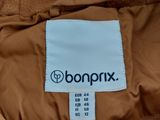 the back of a brown jacket with a white label on it