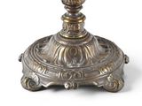 a silver candle holder with a candle on top of it