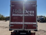 the back of a delivery truck parked in a parking lot