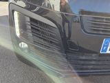 a black car that is parked on the side of the road