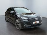 a black audi e - trc parked in a white room