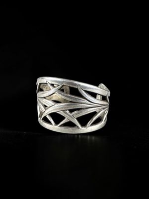 a close up of a silver ring on a black surface