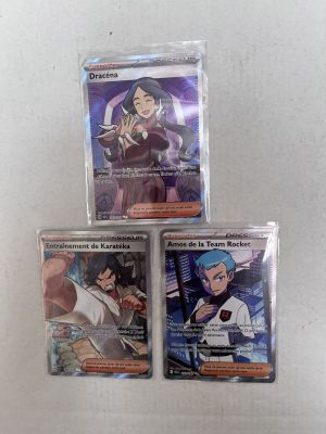 three pokemon cards are sitting on top of each other on a table