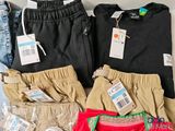 a lot of clothes that are on display on the table