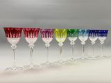 six different colored wine glasses lined up in a row