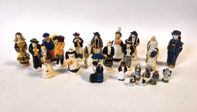 many figurines of people dressed in different costumes
