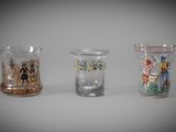 three different colored glass vases sitting next to each other on a table