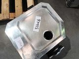 a metal container sitting on the floor next to a pallet
