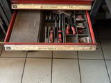 many tools in the drawer on the floor