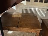 a wooden table and a chair in a room