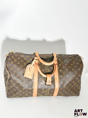 Sac Keepall Louis Vuitton en toile Monogram et cuir