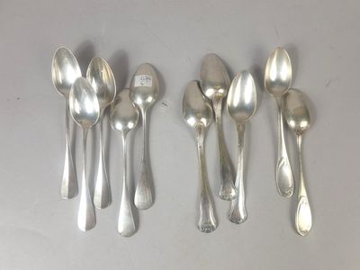 six silver spoons and a spoon with a tag on them