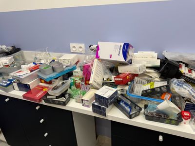 a lot of clutter on the desk in the office
