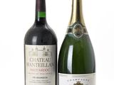 two bottles of wine sitting next to each other on a white surface