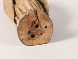 a piece of wood with holes in it on a white surface