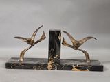 pair of black and gold marble bookends with birds on them