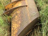 a rusted metal object laying in the grass