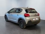 the back of a silver citrole parked in a white room