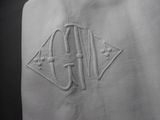 a close up of a white towel with a monogram on it