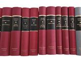 six red books are lined up in a row on a white surface