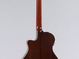 an acoustic guitar on a stand against a white background