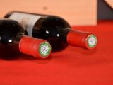 two bottles of wine sitting next to each other on a table