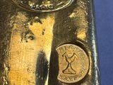 an image of a gold bar with a woman ' s face on it