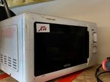 a white microwave sitting on top of a wooden counter