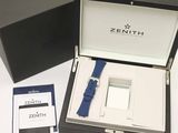 a box with a watch and a card in it