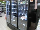 an image of a grocery store with refrigerators in it