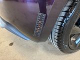 a close up of a car tire with a sticker on it