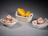 trois paniers blancs remplis de différents types d'aliments, posés sur une table